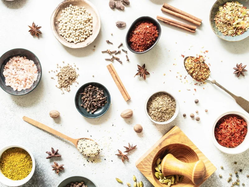 various-dry-spices-in-small-bowls-and-spoons-flat-2025-01-07-06-15-20-utc